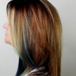 Side profile of a woman with long, multi-toned hair.