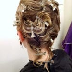 Intricate updo hairstyle with elegant curls and twists.