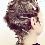 A person with vintage finger wave hairstyle and hair clips.