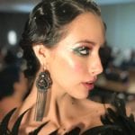 Profile of a woman with glamorous makeup and elegant earrings.