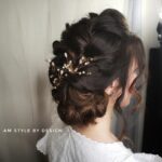 Elegant braided updo with pearl accents.