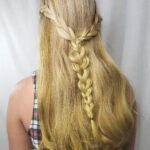 Blonde hair styled in a half-up braided hairstyle.