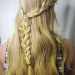 Blonde hair styled with a loose braid and twist from the back.