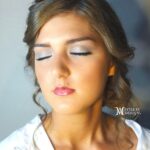 Close-up of a woman with elegant makeup and closed eyes.