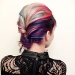 A woman with a colorful, styled updo hairstyle.