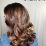Side view of medium-length brown hair with soft curls.