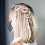 Side view of blonde hair with a braided half-up hairstyle.