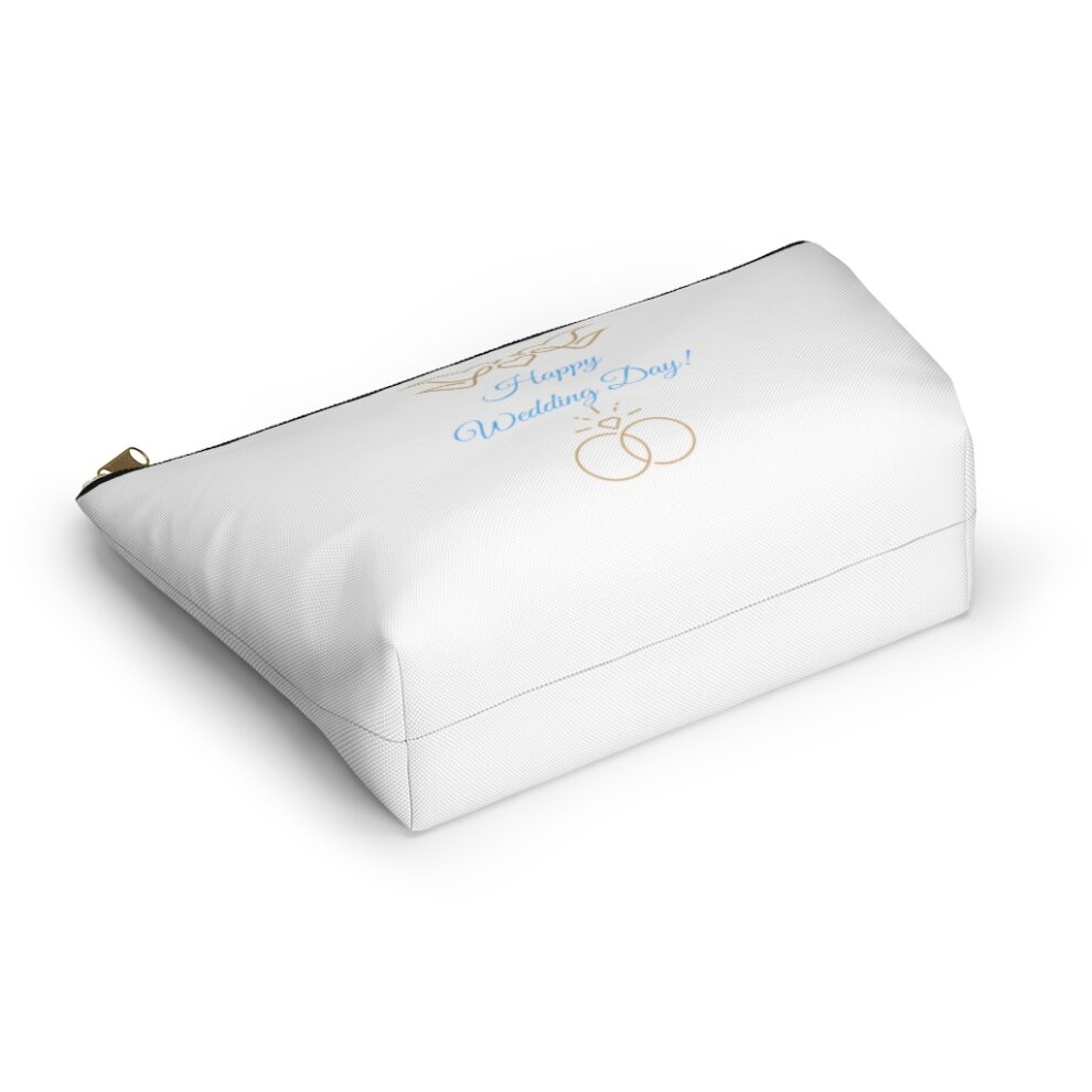 A white pillow with a blue and white design.
