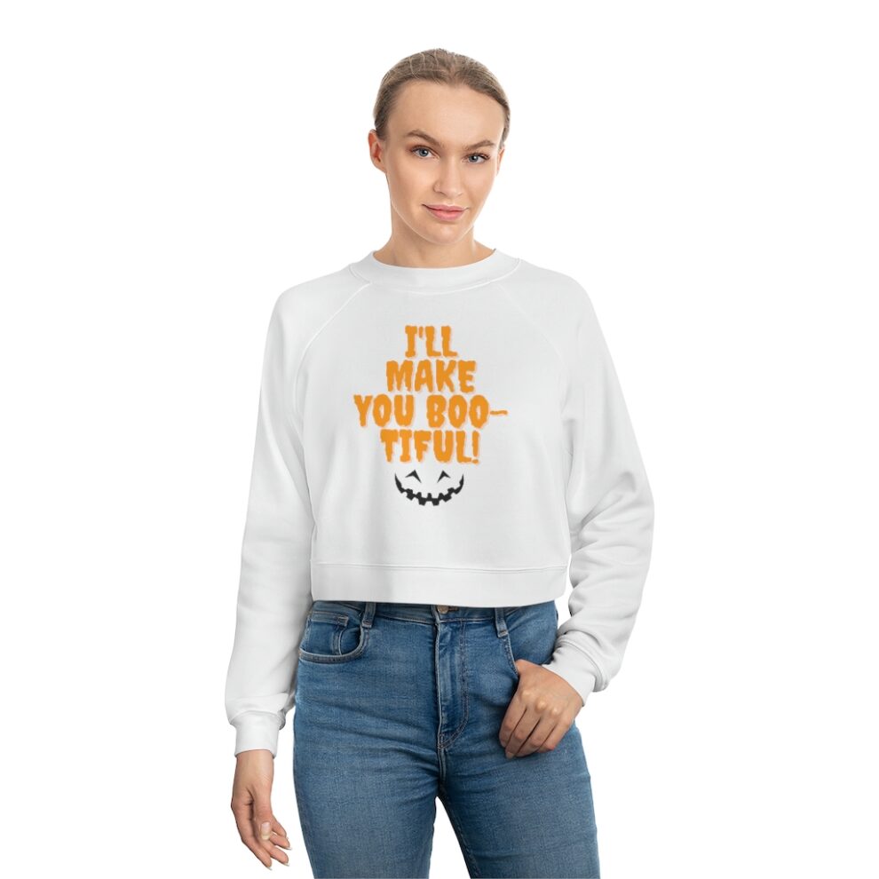 A woman wearing a white sweatshirt with an orange smiley face.