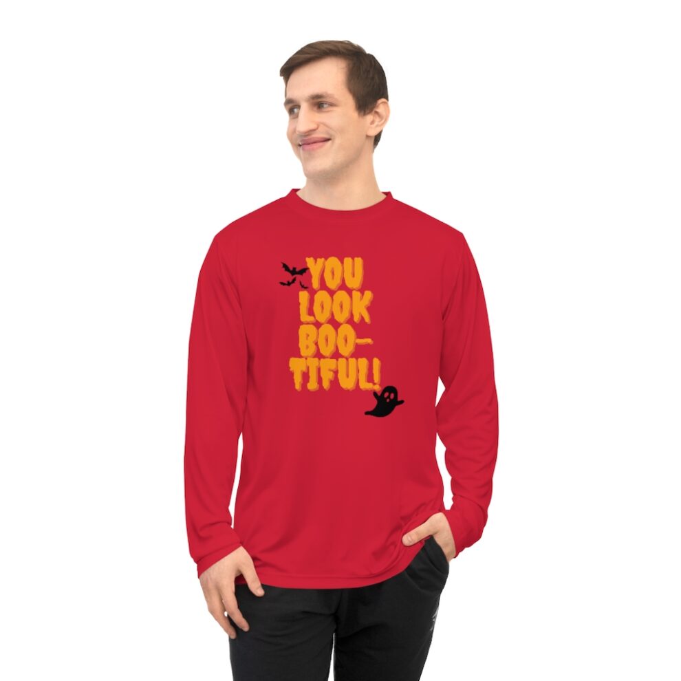 A man wearing a red long sleeve shirt with the words " you look so-ttiful !" on it.