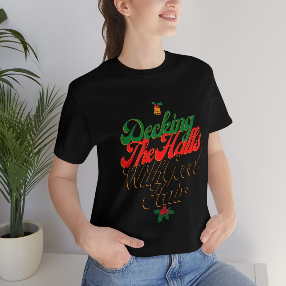 A woman sitting on the ground wearing a t-shirt.