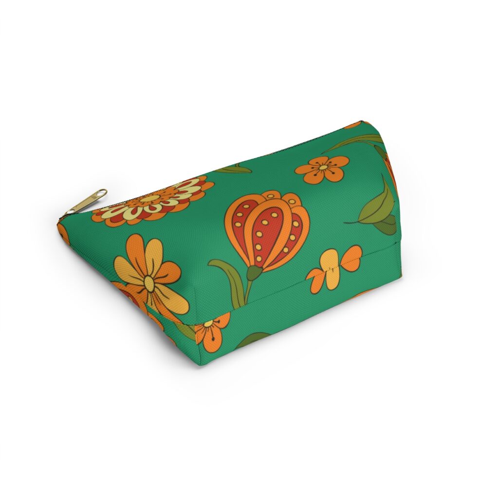 A green bag with orange flowers on it.