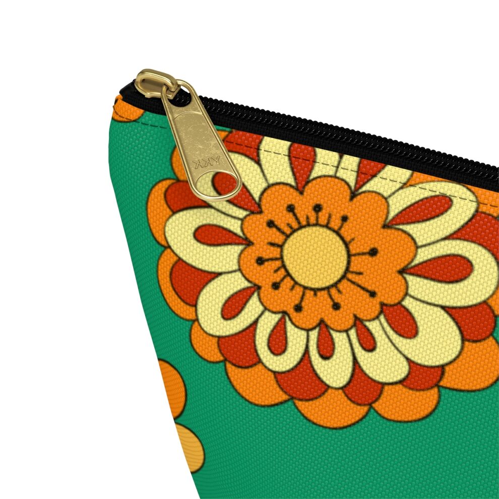 A close up of the zipper on a green and orange flower pouch