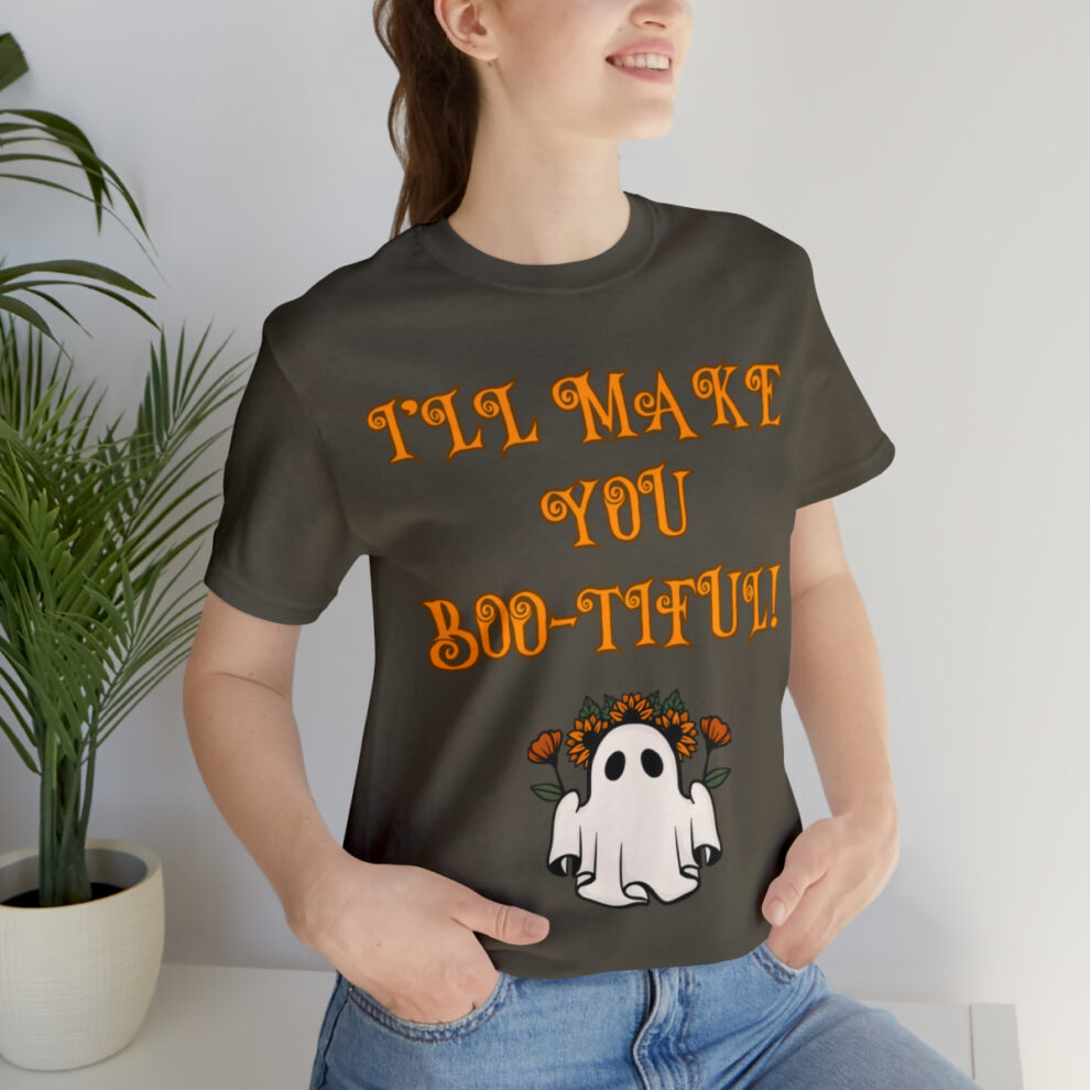 A woman sitting on the ground wearing a t-shirt.