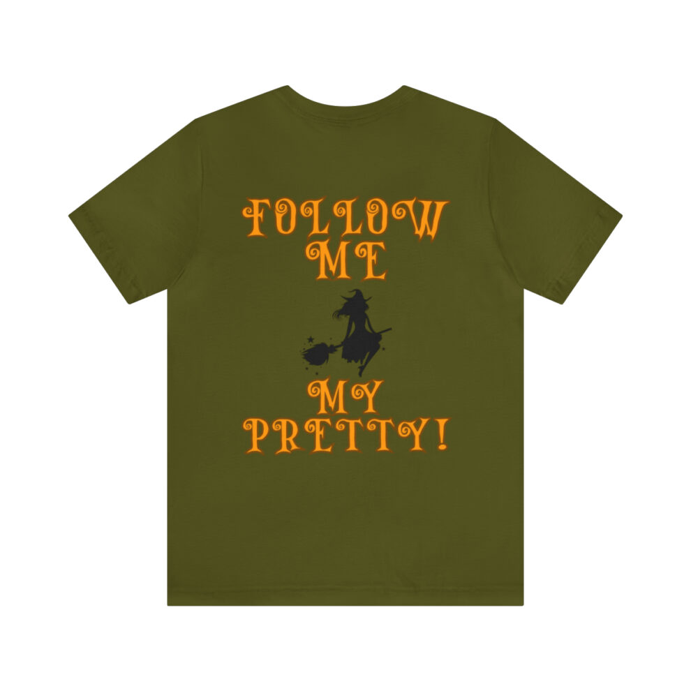 A green t-shirt with an image of a witch on it.
