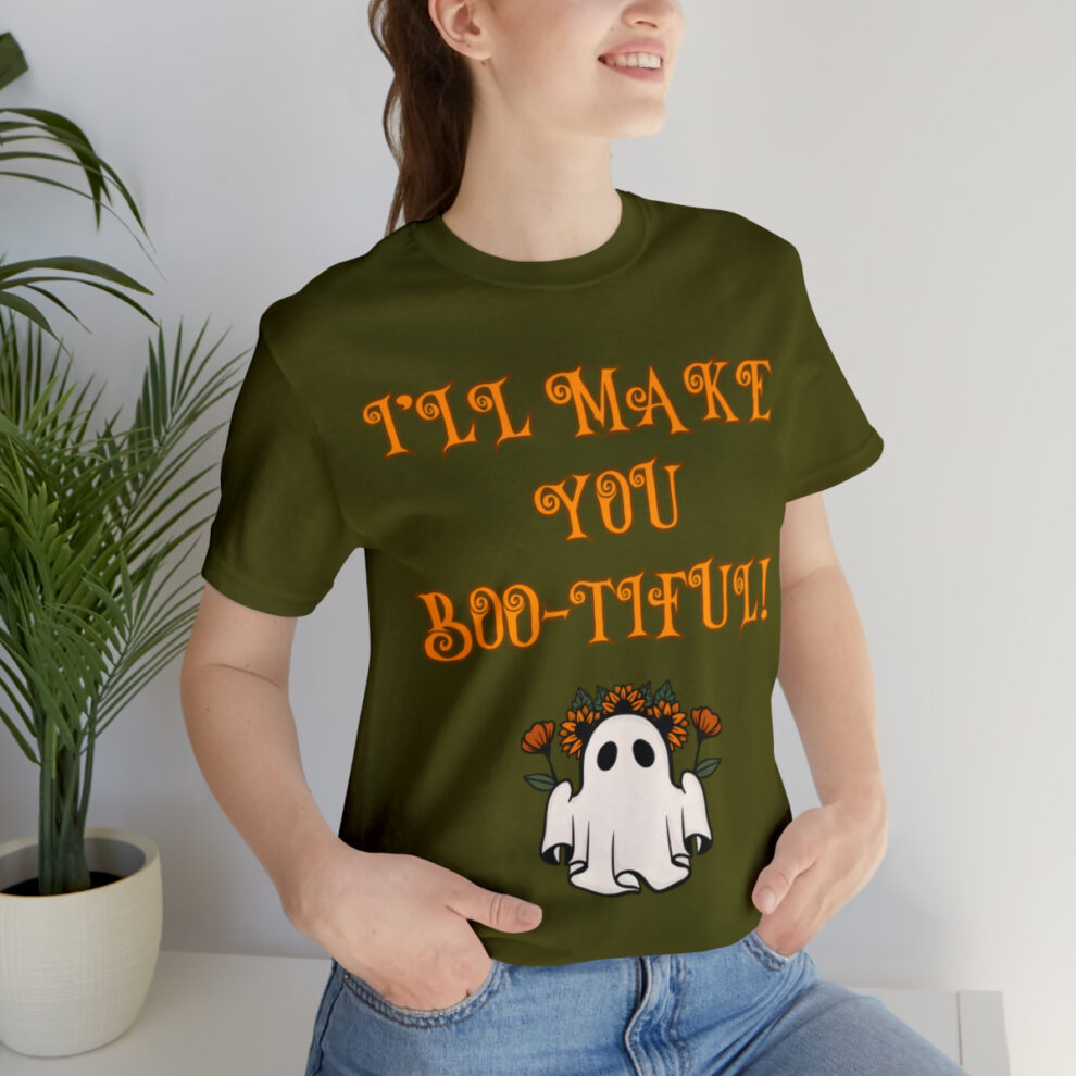 A woman sitting on the ground wearing a t-shirt.