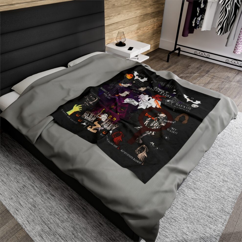 A bed with a black and grey comforter on it