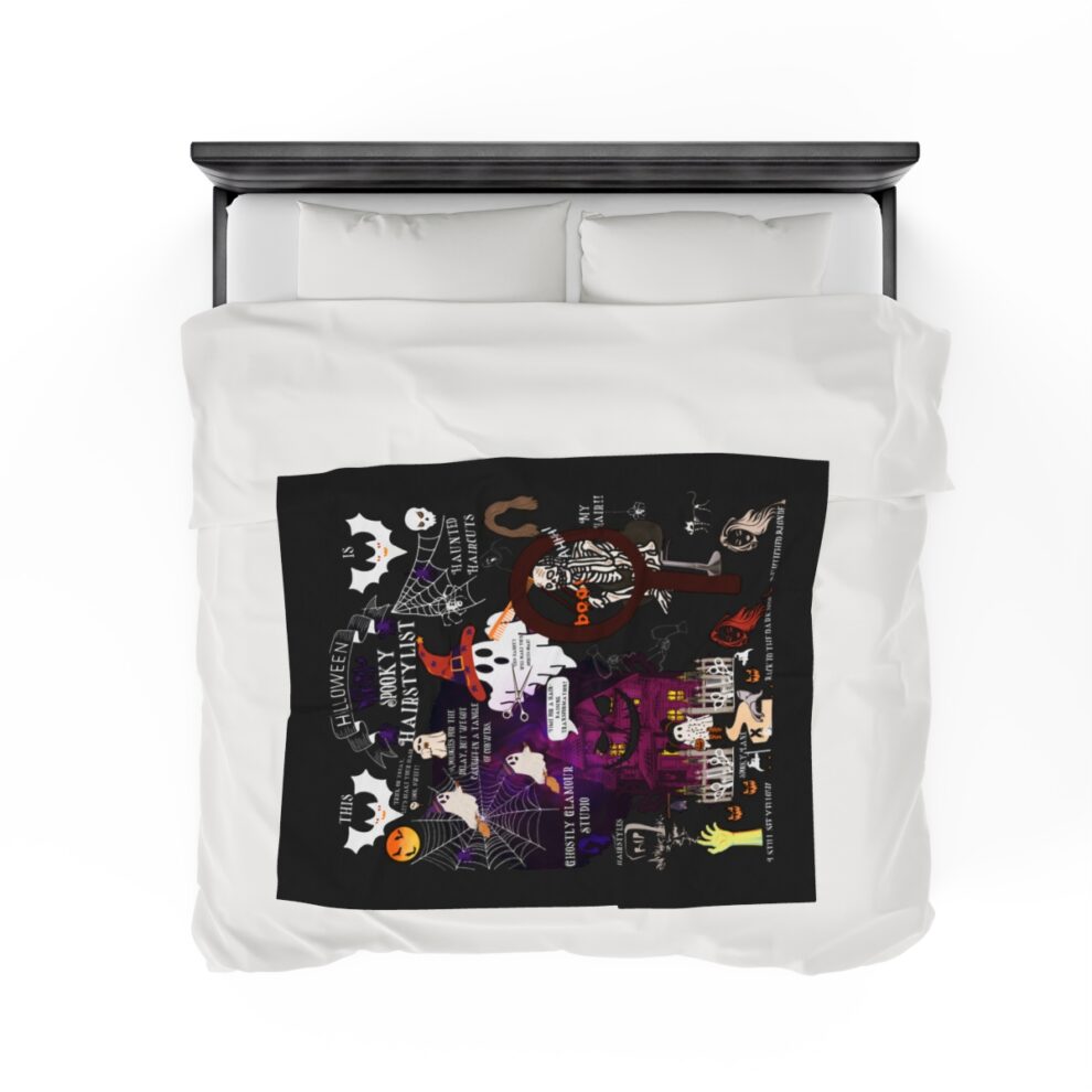 A white comforter with black and purple artwork.