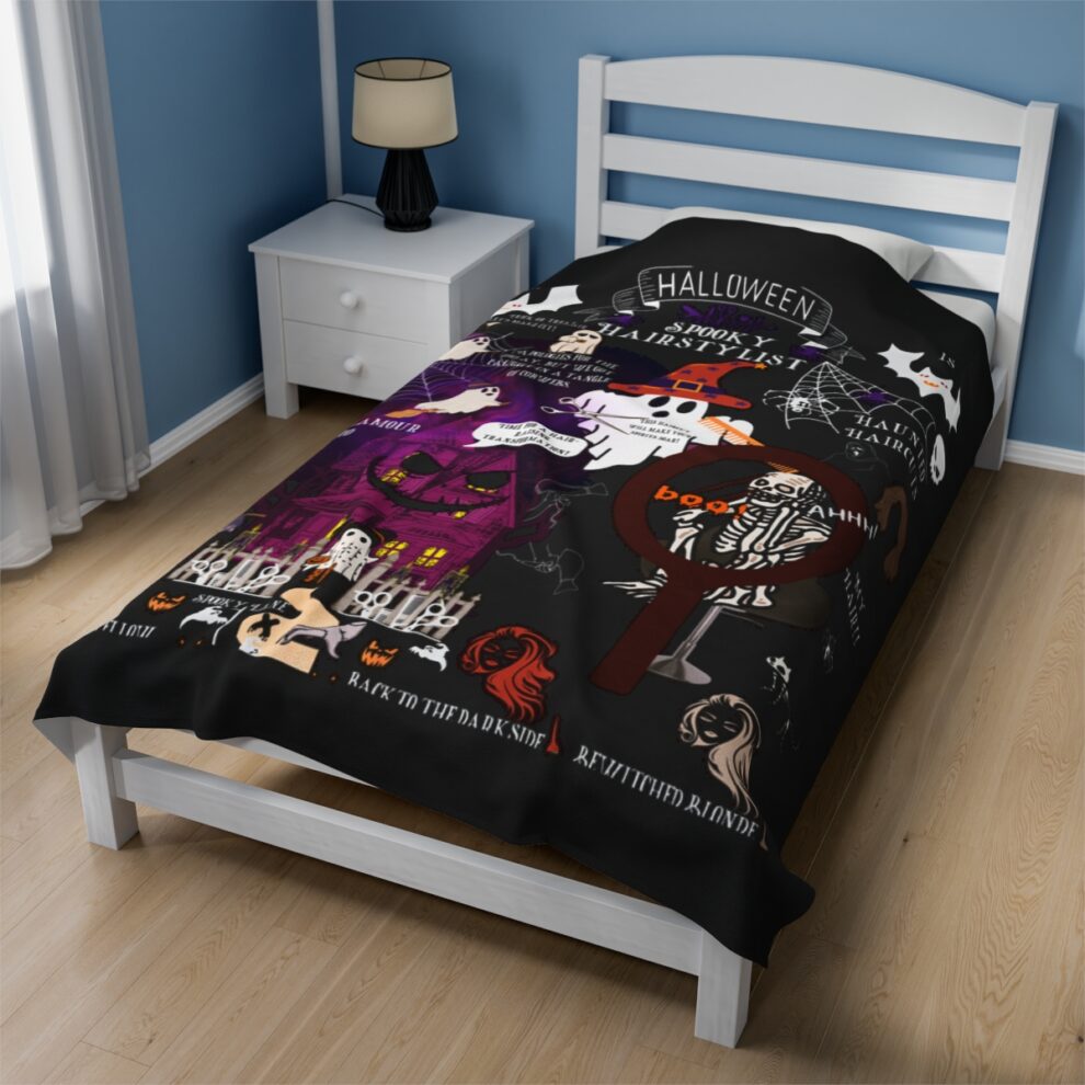 A bed with a black sheet and white pillow