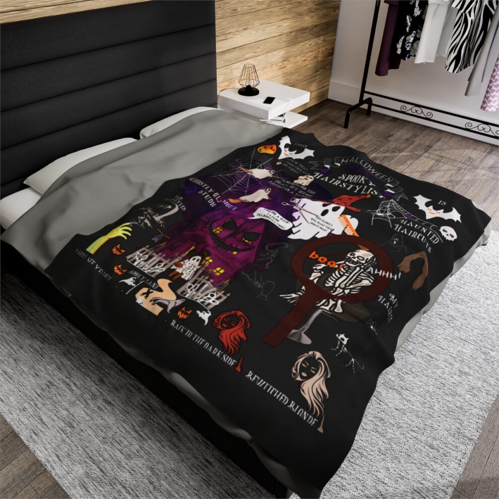 A bed with a black and white blanket on it