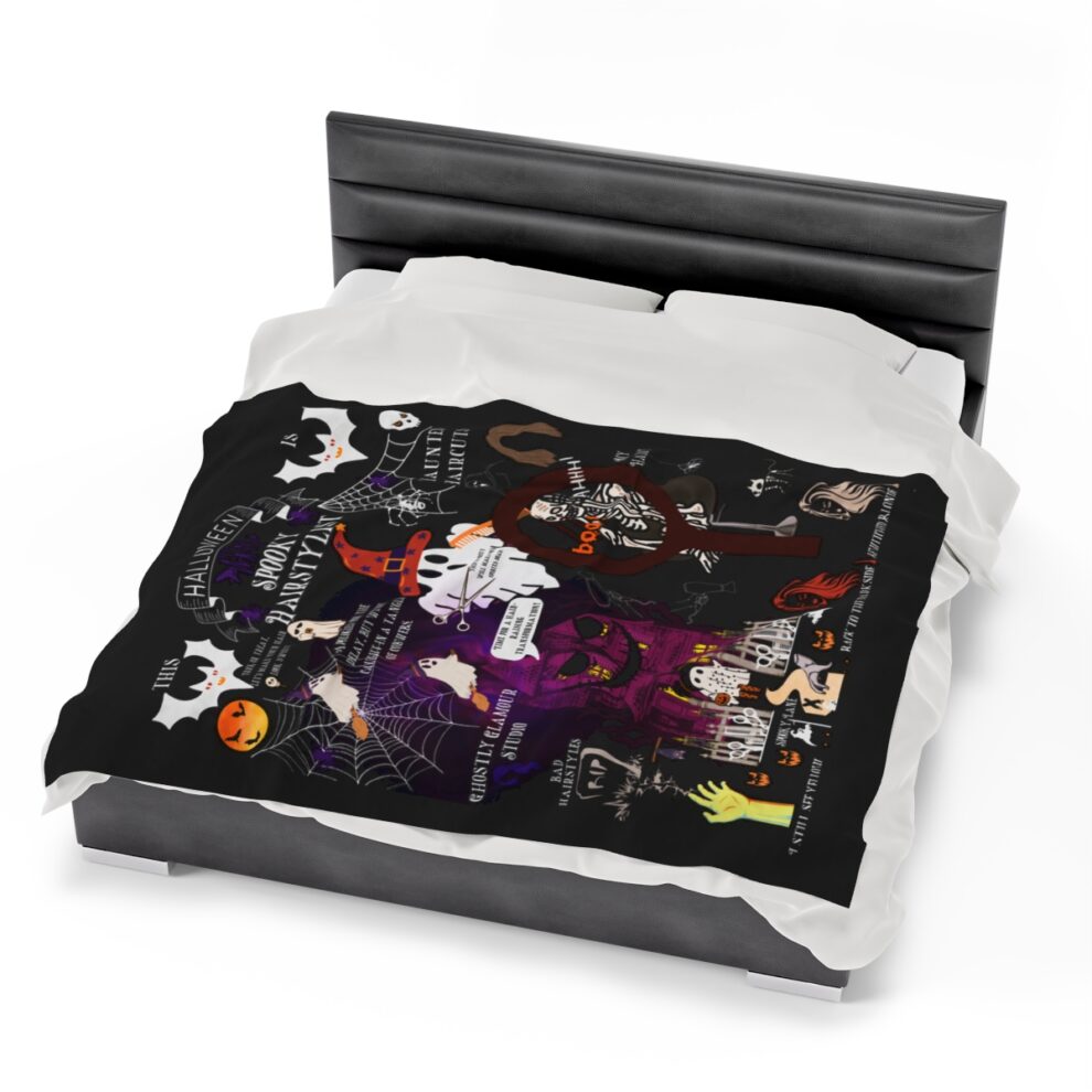 A bed with black sheets and white pillows.