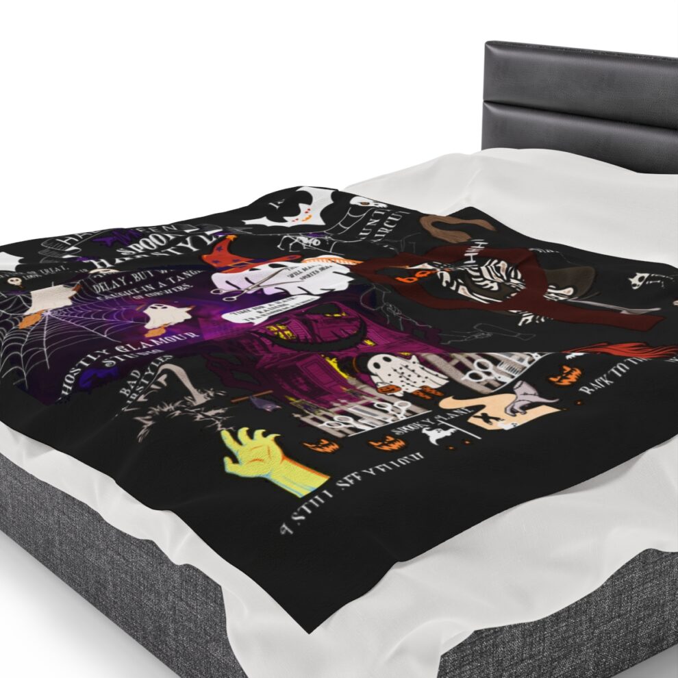 A bed with a black and white blanket on it