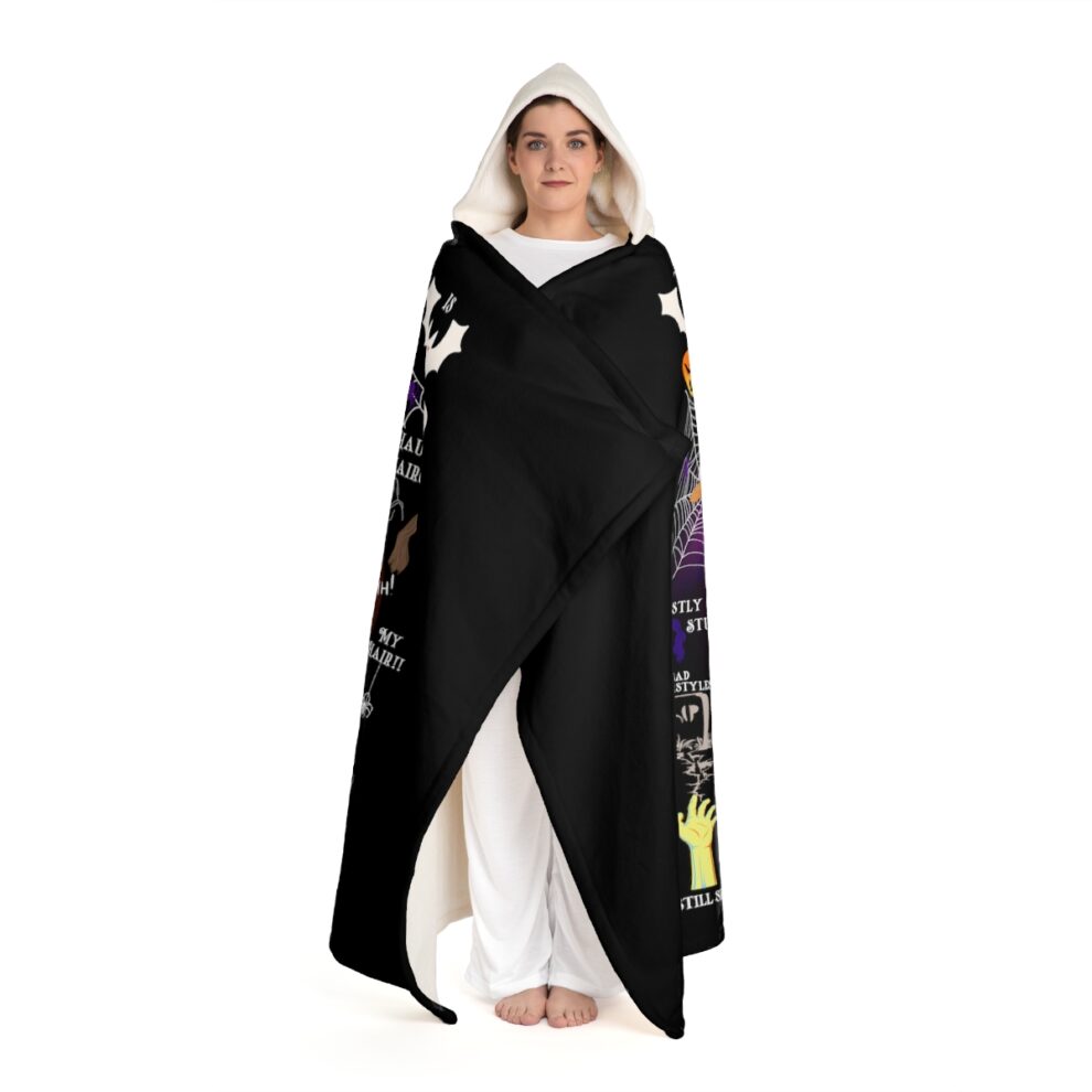 A woman in white pants and black hooded sweatshirt.