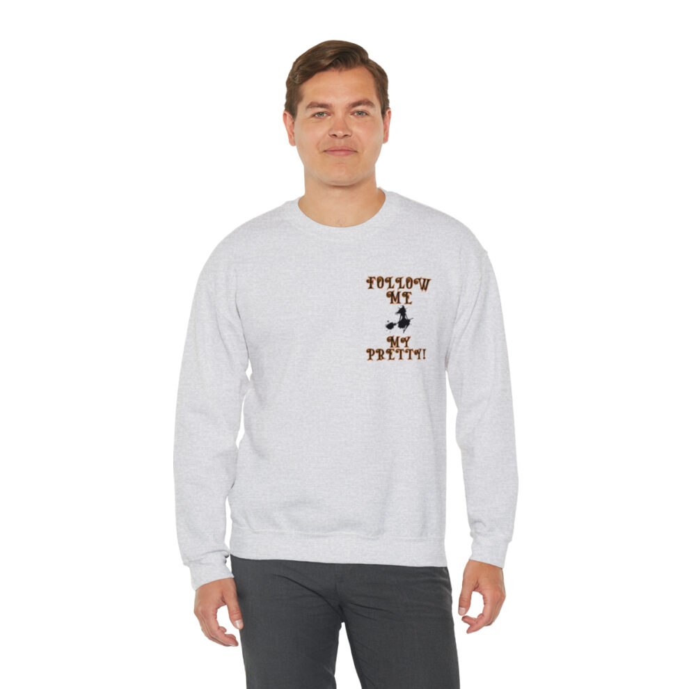 A man wearing a white sweatshirt with a brown and black design.