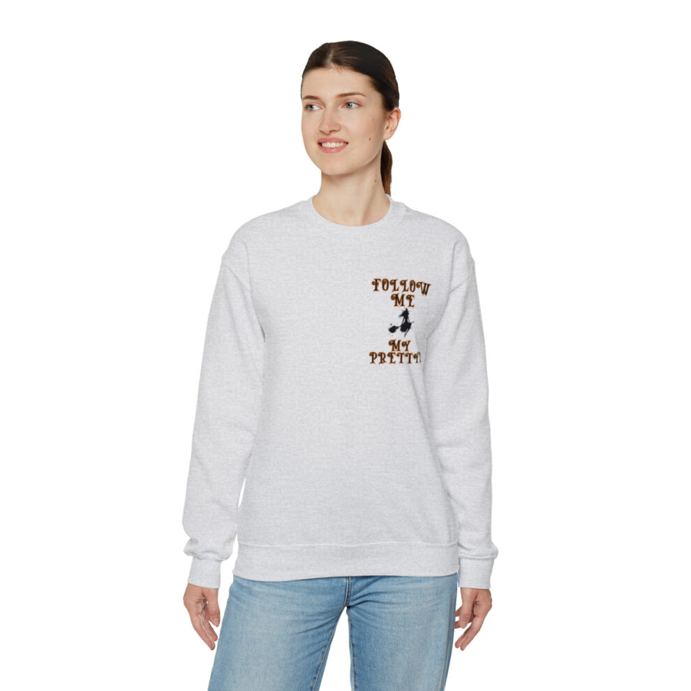 A woman wearing a white sweatshirt with a brown and black design.