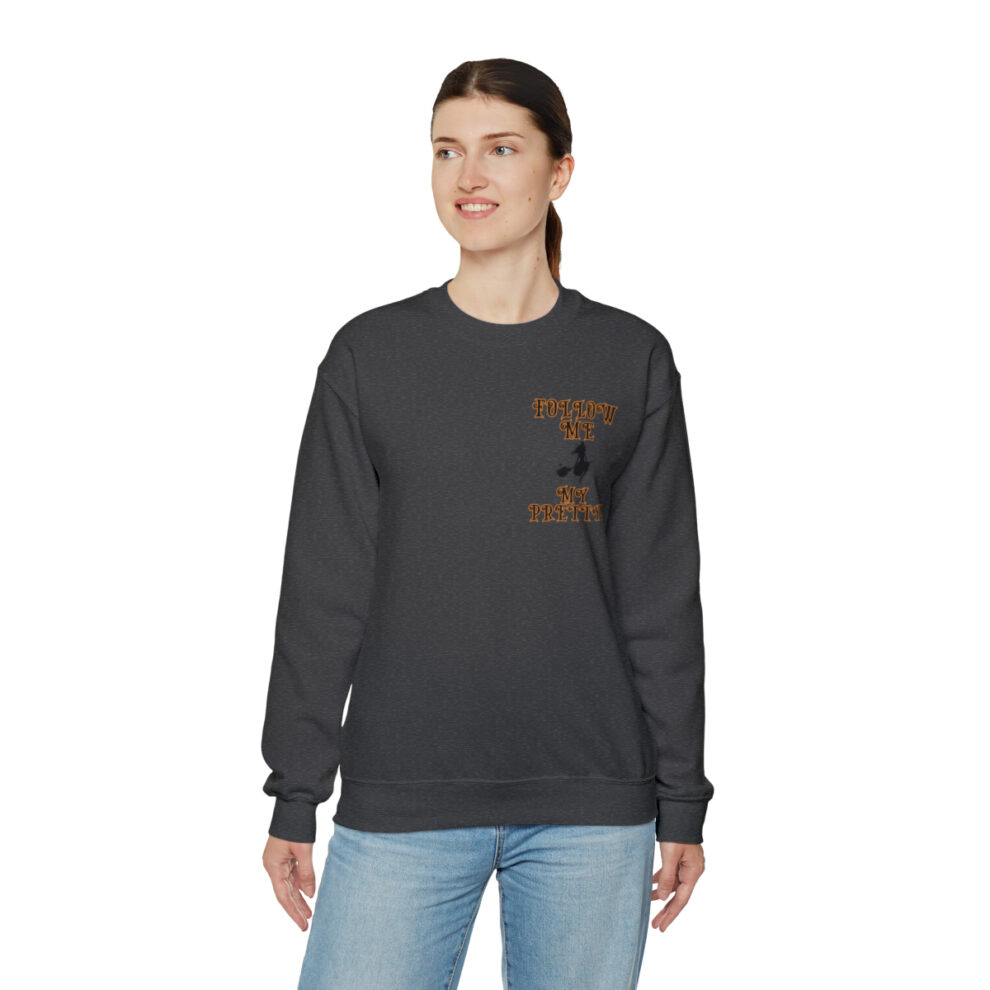 A woman wearing a black sweatshirt with an orange logo.