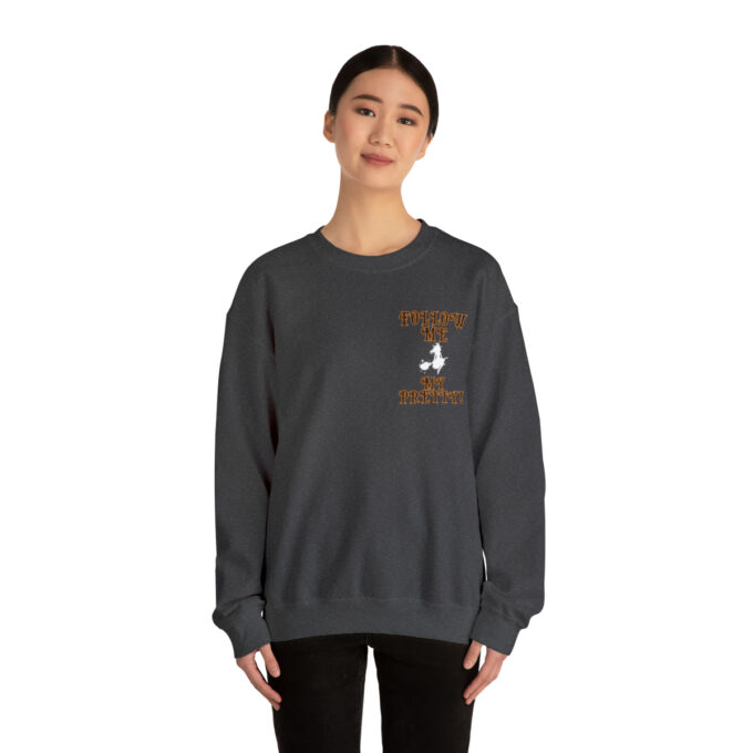 A woman wearing a sweatshirt with an image of a bird on it.
