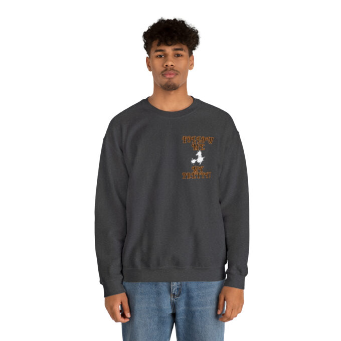 A man wearing a sweatshirt with an image of a person on it.