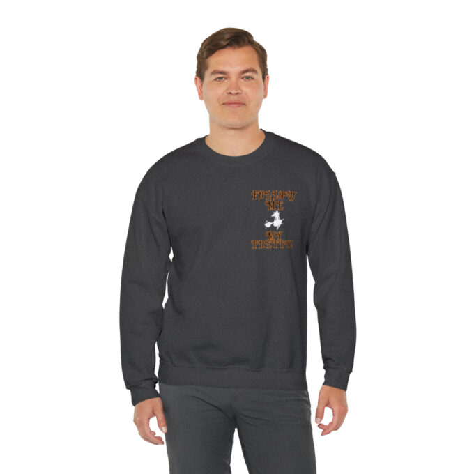 A man wearing a black sweatshirt with an orange logo.