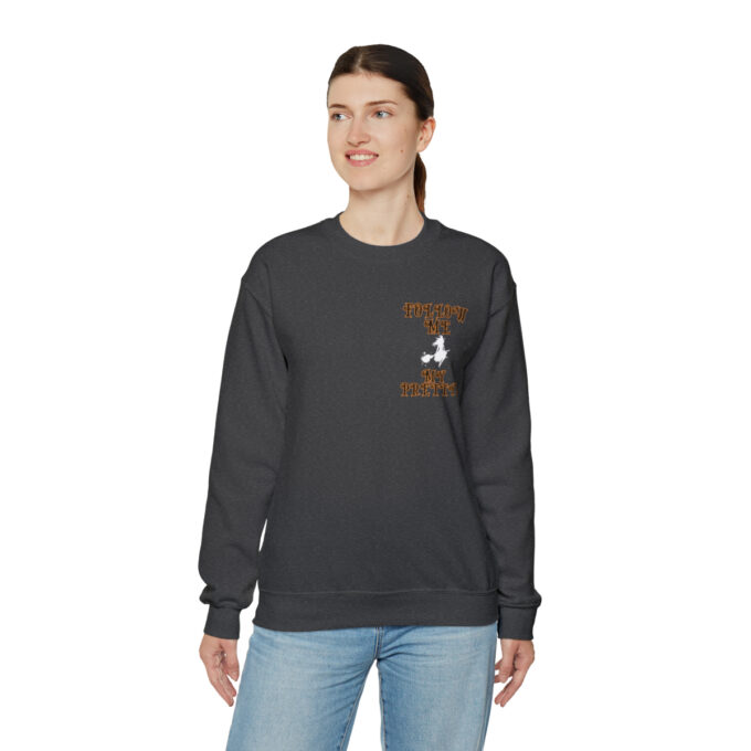 A woman wearing a black sweatshirt with an image of a person on it.
