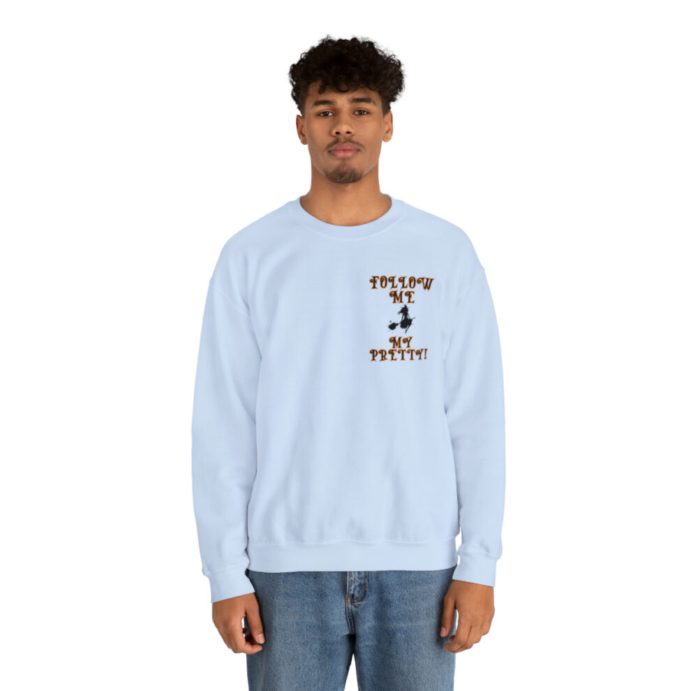 A man in a light blue sweatshirt with an image of a person on it.