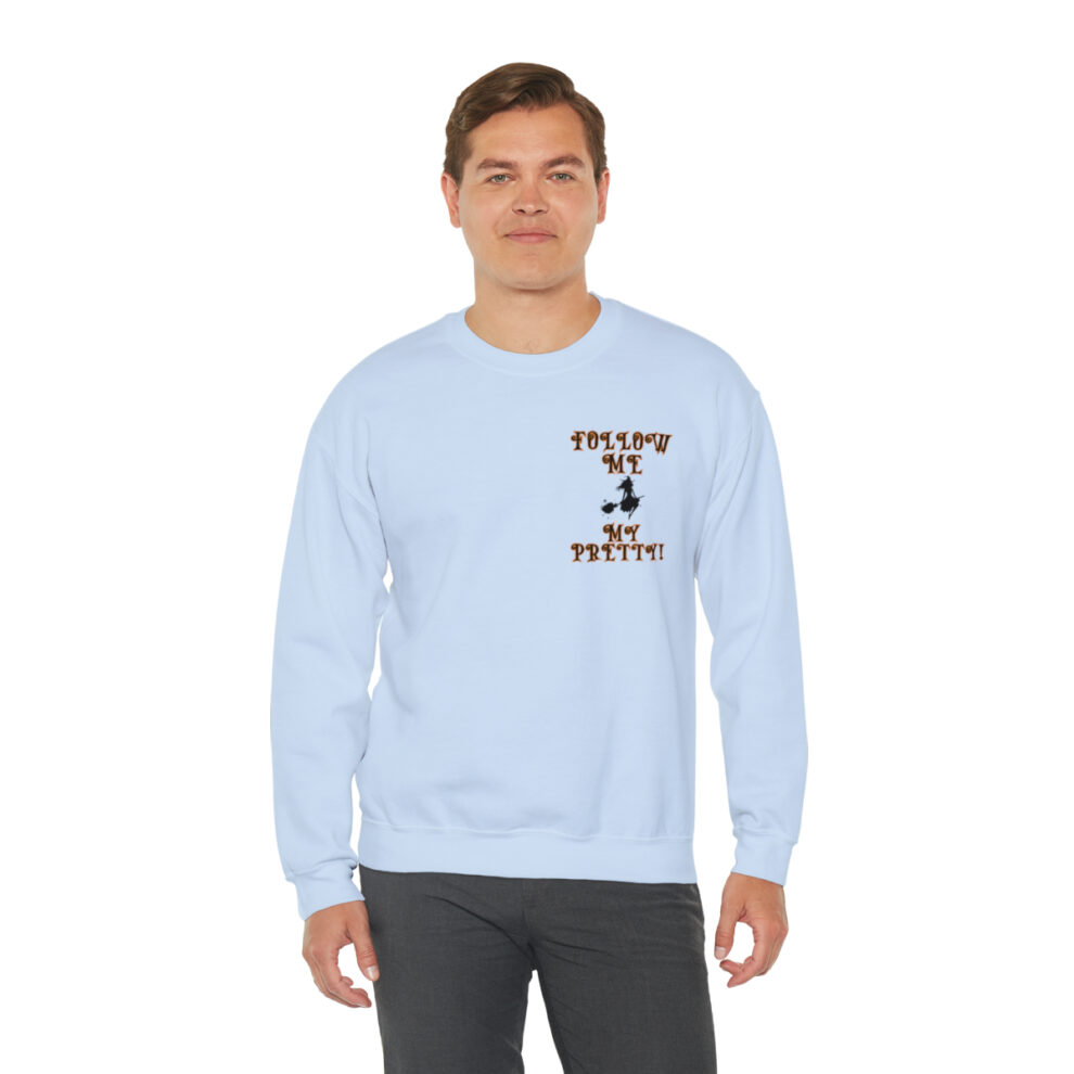 A man wearing a light blue sweatshirt with an image of a person.