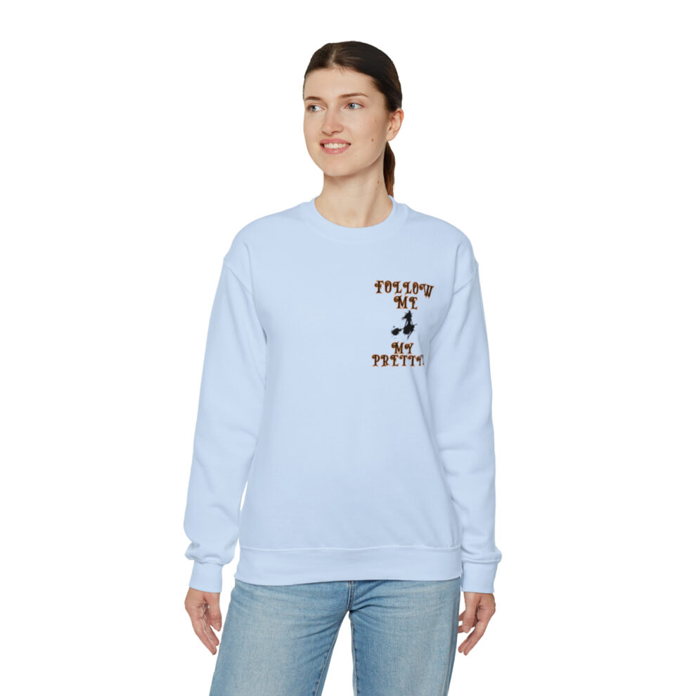 A woman wearing a light blue sweatshirt with the words " chicago cubs " on it.