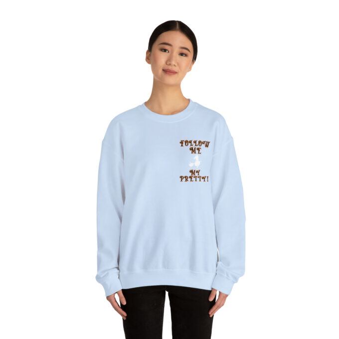 A woman wearing a light blue sweatshirt with an image of a dog.