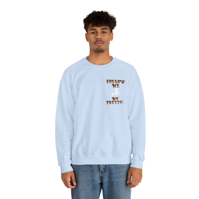 A man in a light blue sweatshirt with an image of a dog.