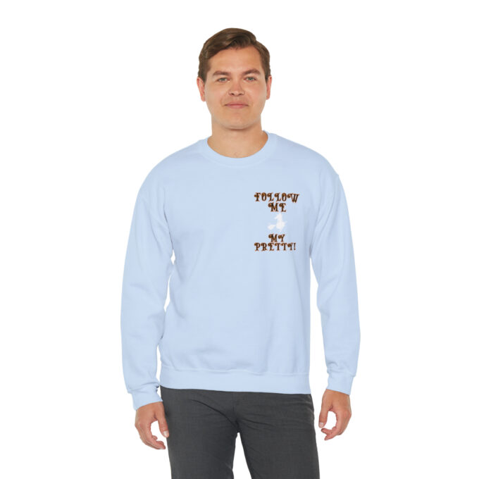 A man in a light blue sweatshirt with the words " follow me to paradise ".