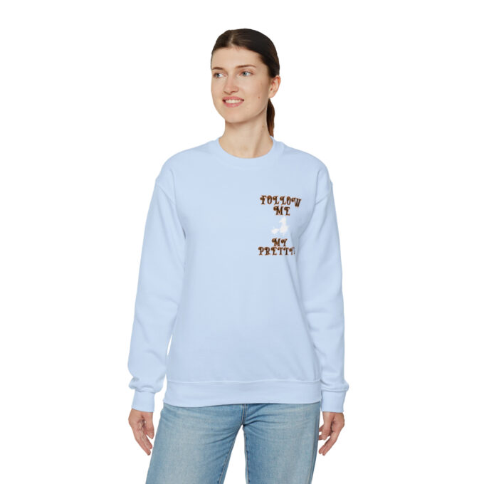 A woman wearing a light blue sweatshirt with the words " dreams do not expire ".