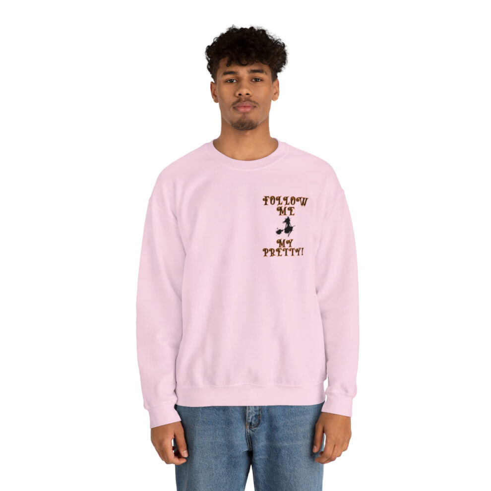 A man in a pink sweatshirt with a brown dog on the front.