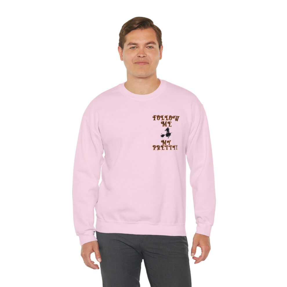 A man in a pink sweatshirt with the words " everyone is pretty ".