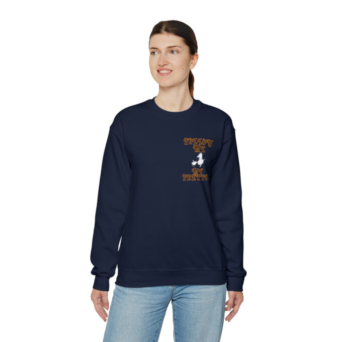 A woman wearing a navy blue sweatshirt with an image of a person on it.