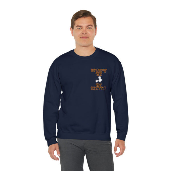 A man wearing a navy blue sweatshirt with an orange and white design.