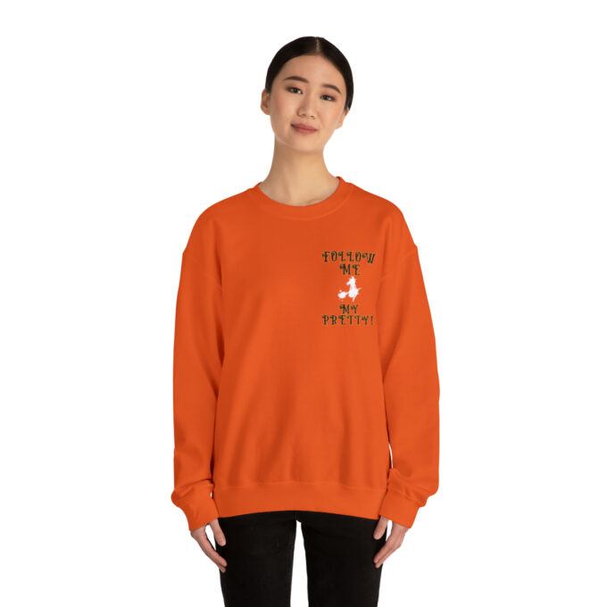 A woman wearing an orange sweatshirt with the words " you can 't touch this " on it.