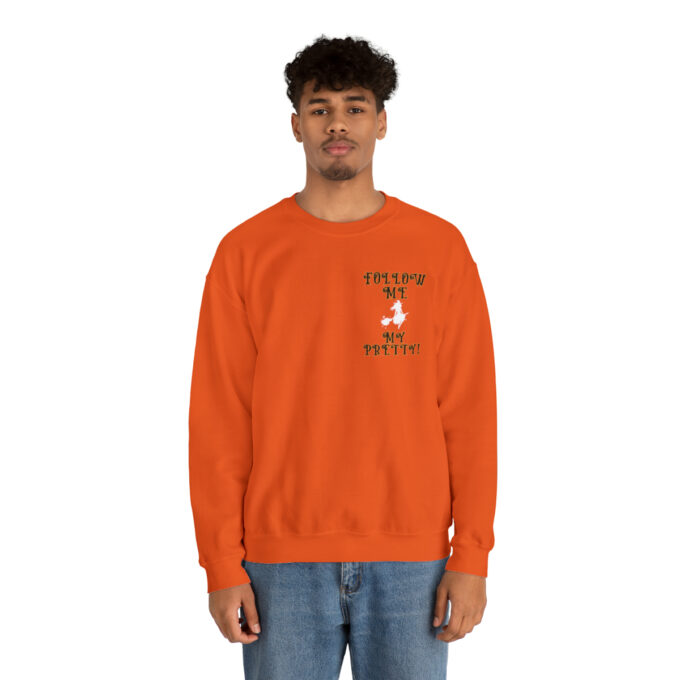 A man in an orange sweatshirt with a dog on the front.