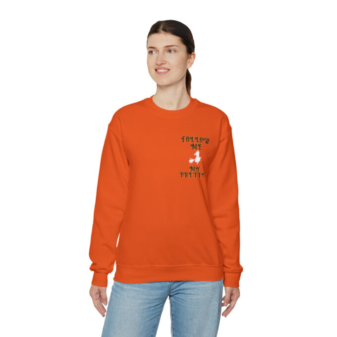 A woman wearing an orange sweatshirt with the words " hello my name is " on it.