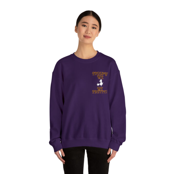 A woman in purple sweatshirt with a bird on the front.