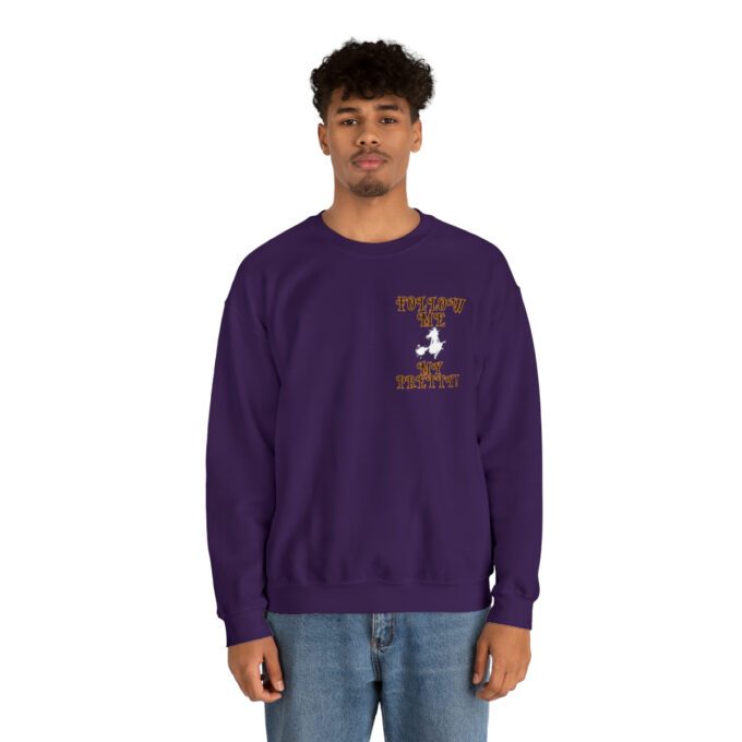 A man in purple sweatshirt with a bird on the front.